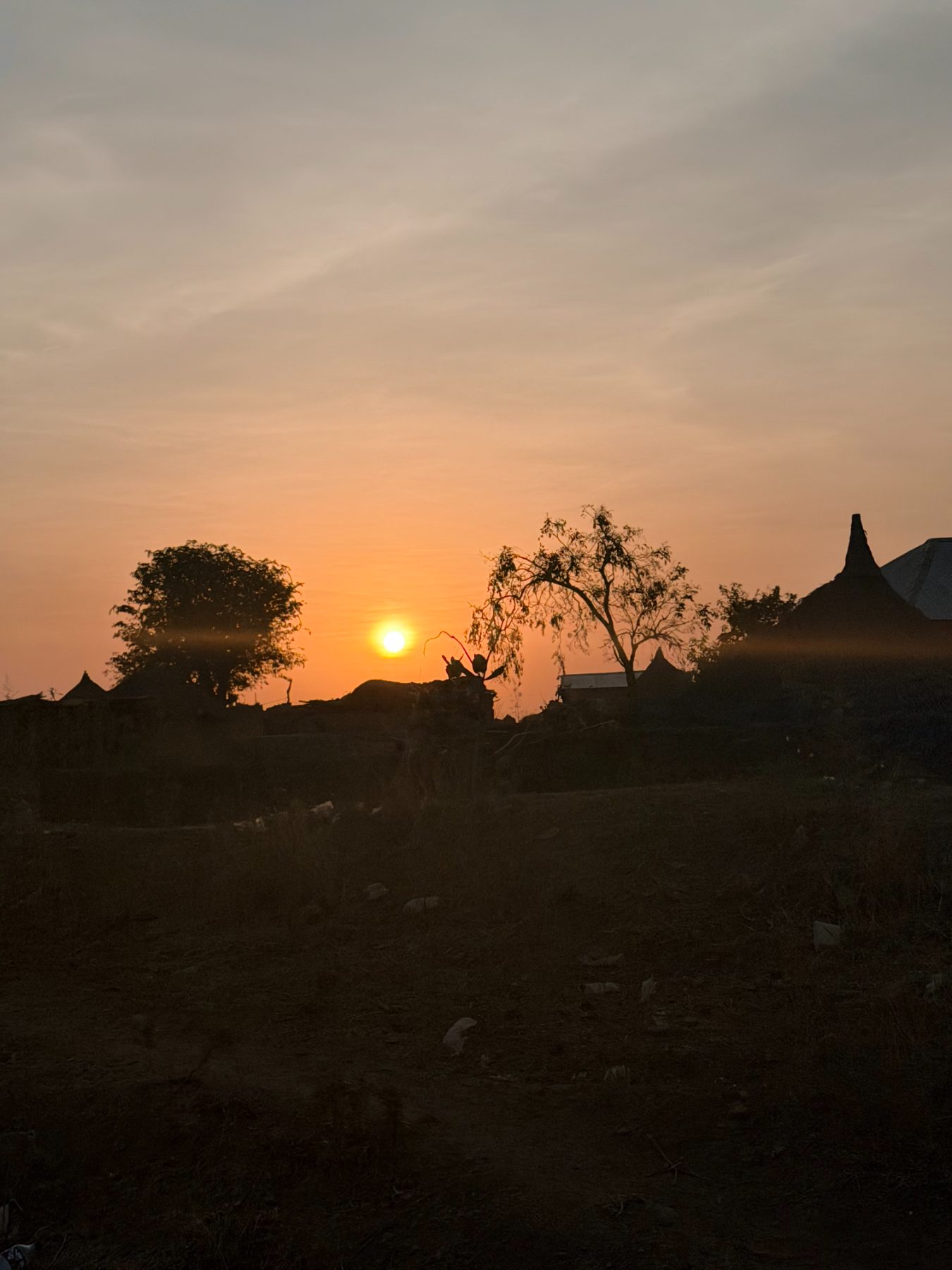 Sunset over a village on the edge of the savannah